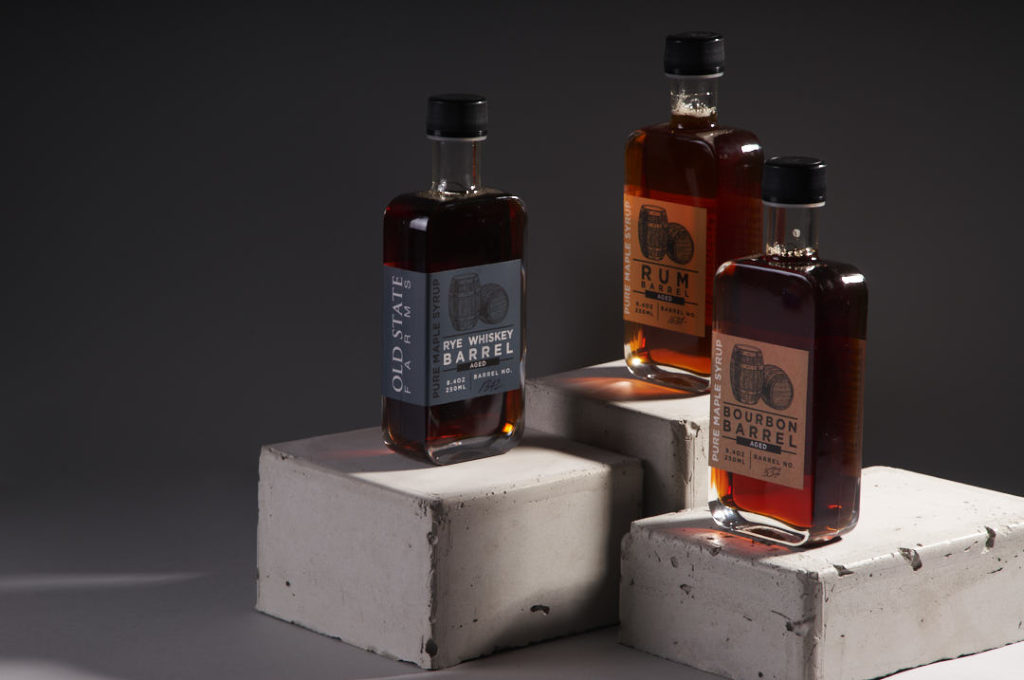 Images of three bottles of rye whiskey, rum, bourbon maple syrup
