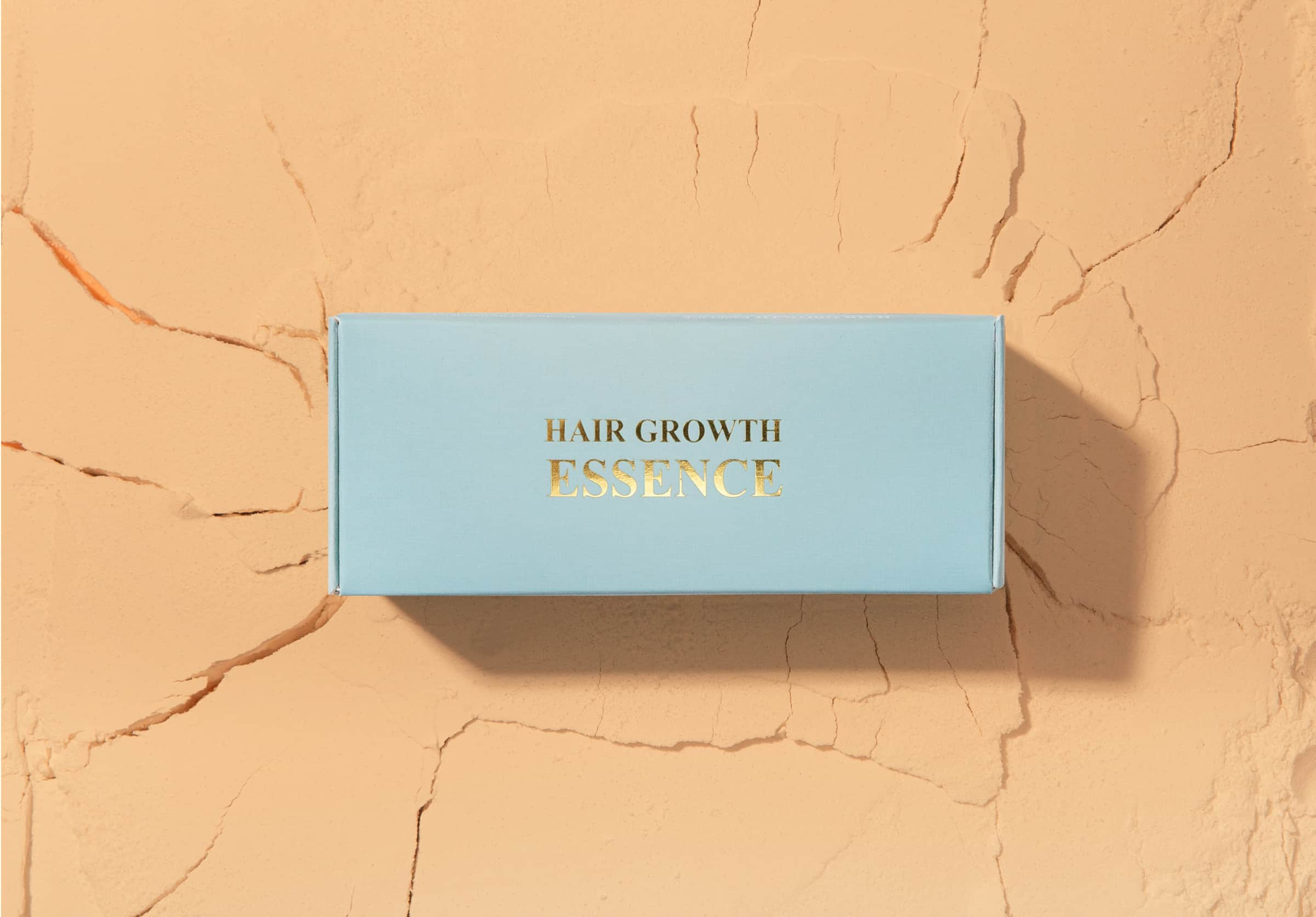 Hair growth serum product box packaging with gold foil stamping.