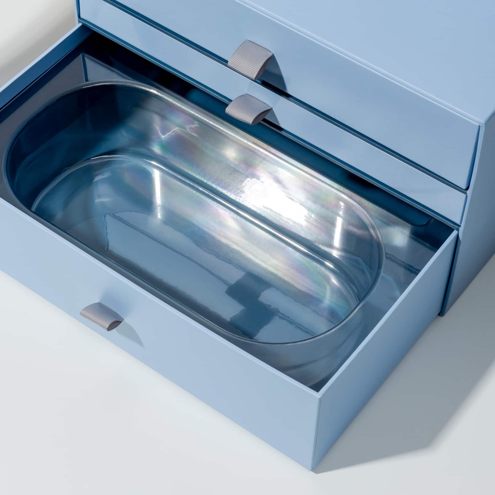 blister or plastic insert inside a rigid drawer box