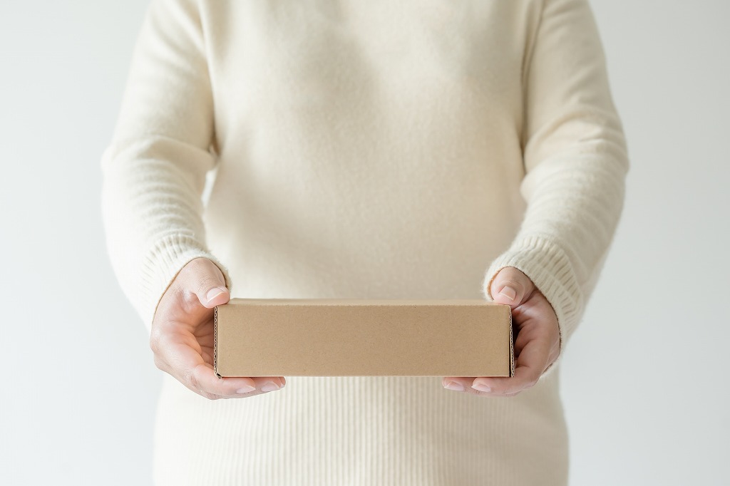 Woman carrying a discreet packaging mailer box